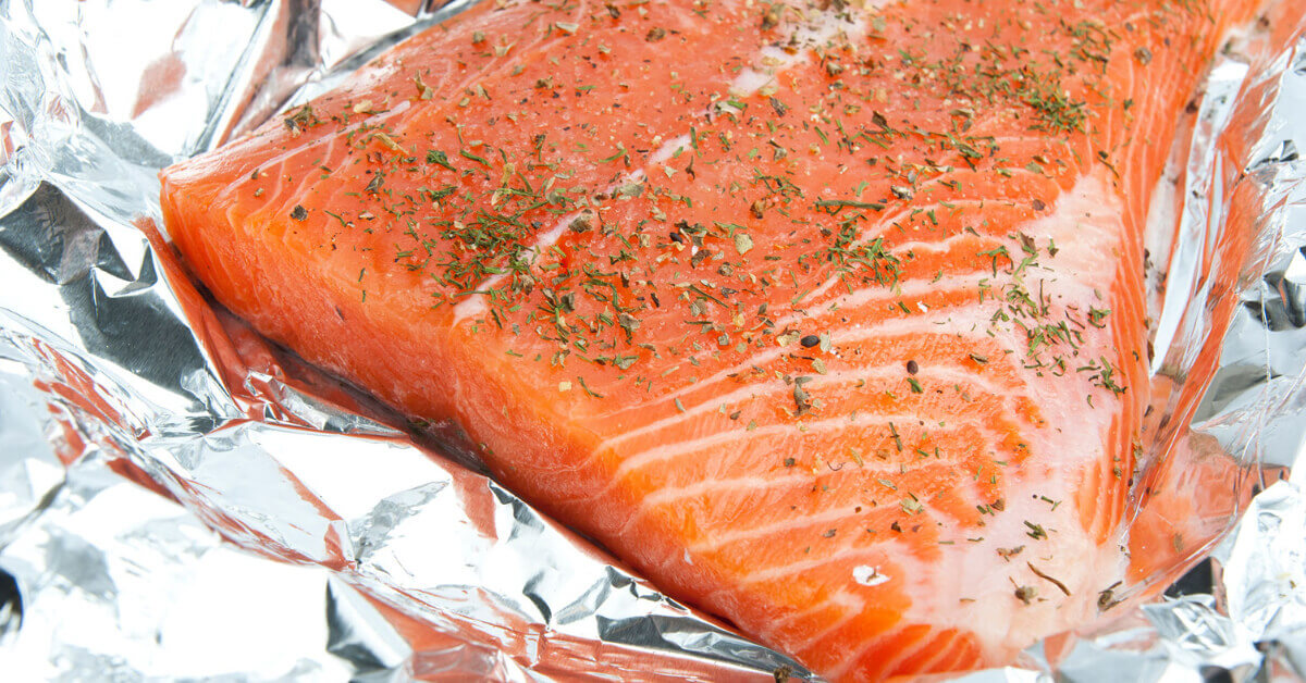 A Salmon Filet wrapped in aluminum foil ready to cook over the campfire