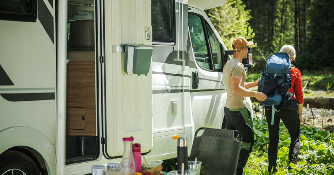 A man and woman getting ready to hike while they are boondocking in their RV