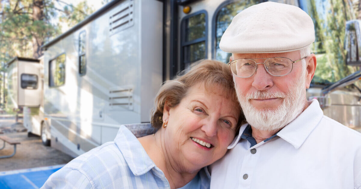 Senior Couple standing outside of their RV