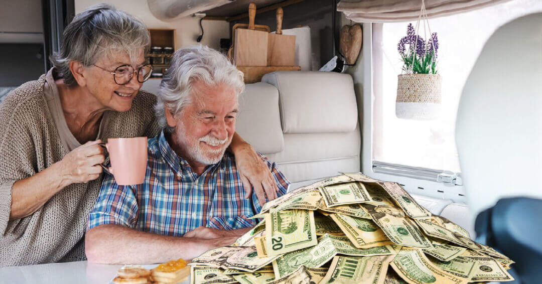 A couple starting at a pile of cash on their RV's dining table