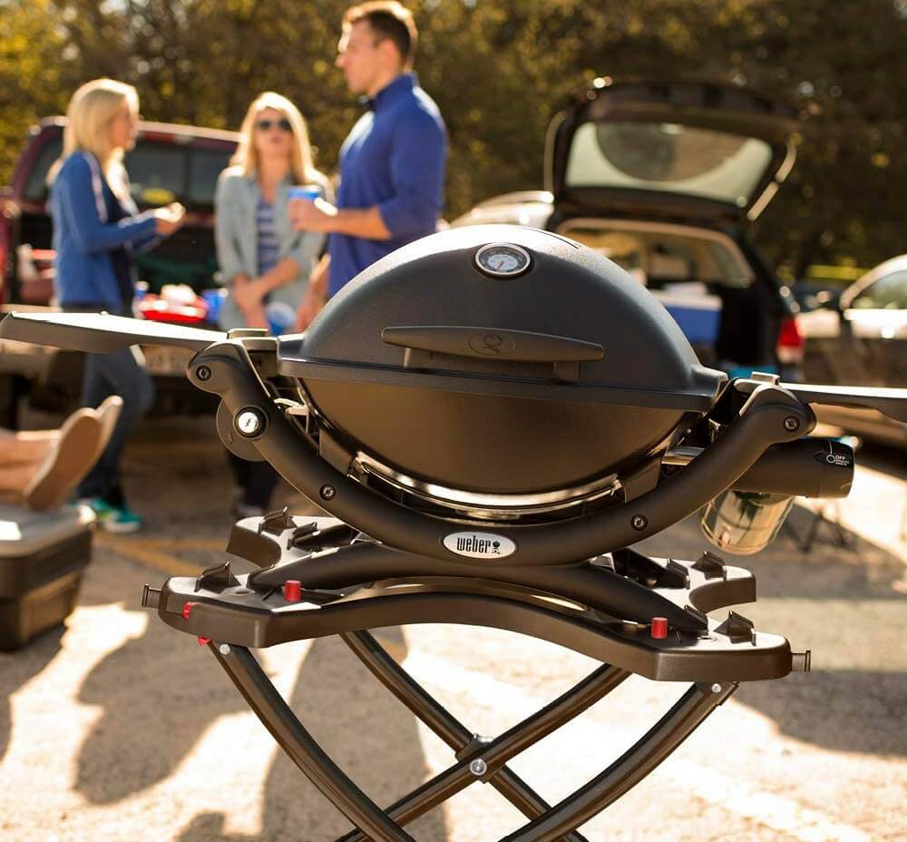 A portable grill at a tailgating party