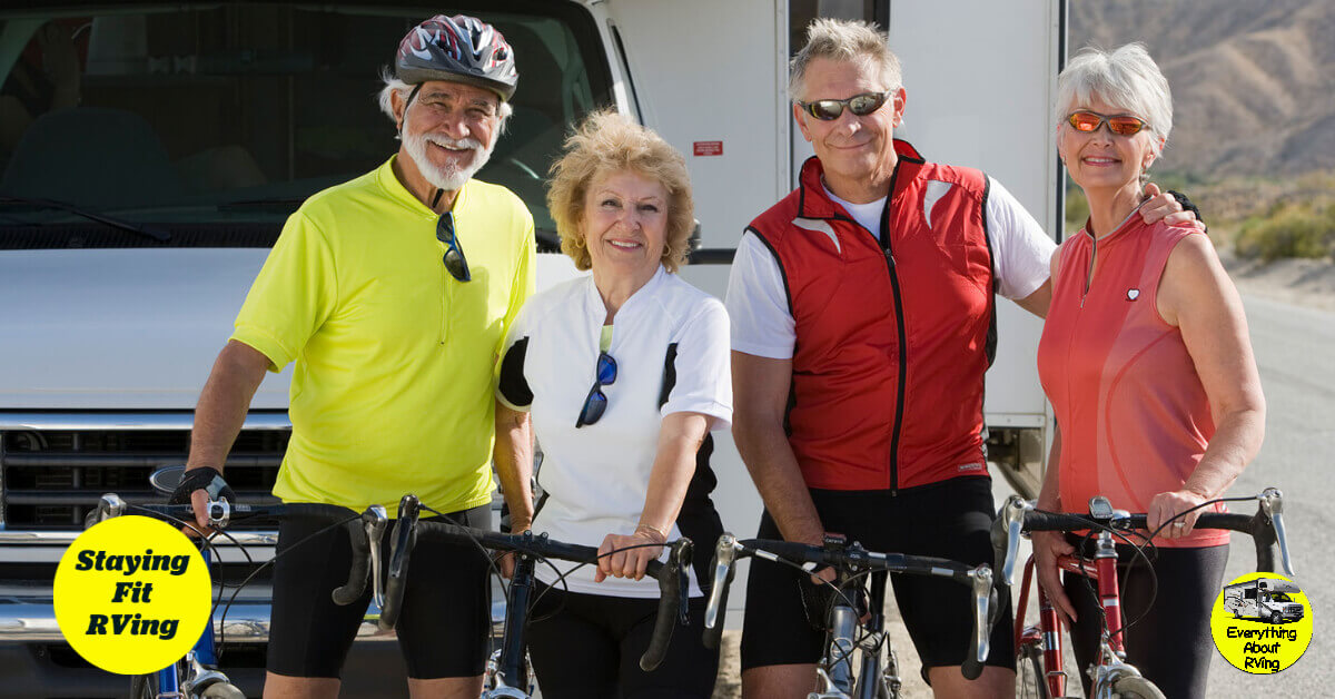 2 males and 2 females standing in front of an RV with their bicycles