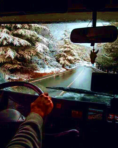 drivers view driving on a snowy mountain road