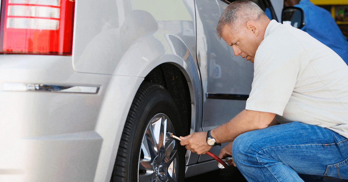 RVer checking the tire pressure on his motorhome