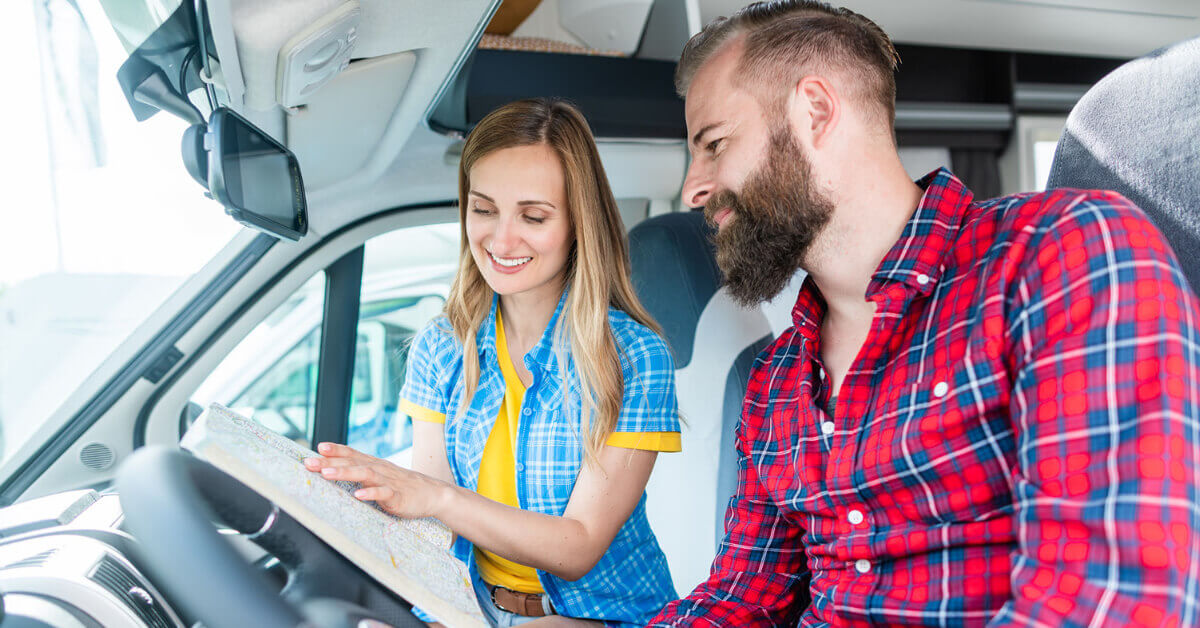 New RVers in their RV using a map to plan their first RV Adventure