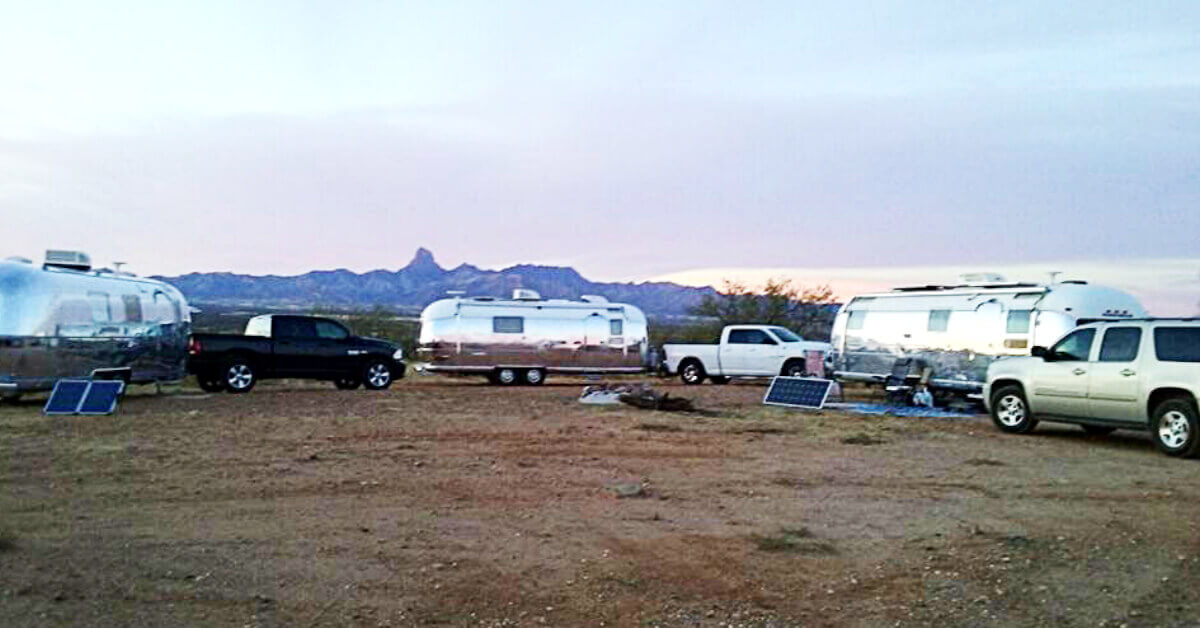 A group of RVers in Travel Trailers boondocking in the desert