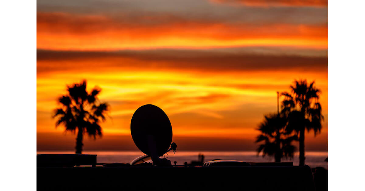 RV with TV Satellite dish during sunset