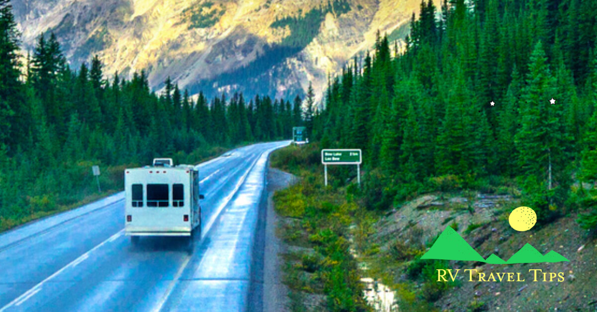 Class C RV traveling on a forested mountain road
