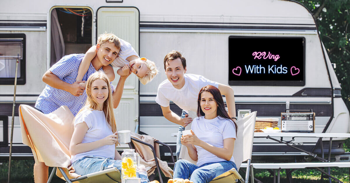 Family sitting outside of their Travel Trailer