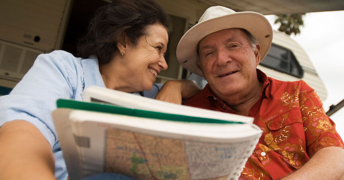 RVing couple using a map to plan their RVing adventure