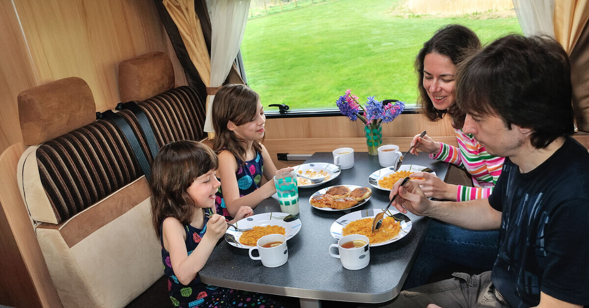 Family eating breakfast in their RV