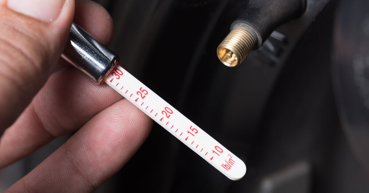 RVer checking tire air pressure on their travel trailer