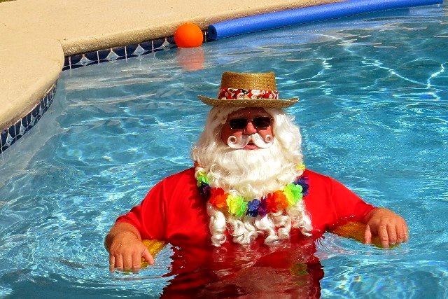 Santa Claus swimming in the pool at the Wekiva Falls RV Resort located in Sorrento Florida